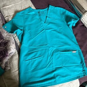 FIGS Casma 3 pocket teal scrub top.